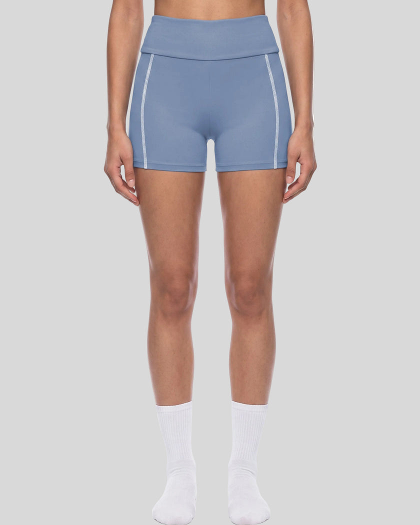 Lower body front view of woman wearing TrackLine Yoga Shorts in blue