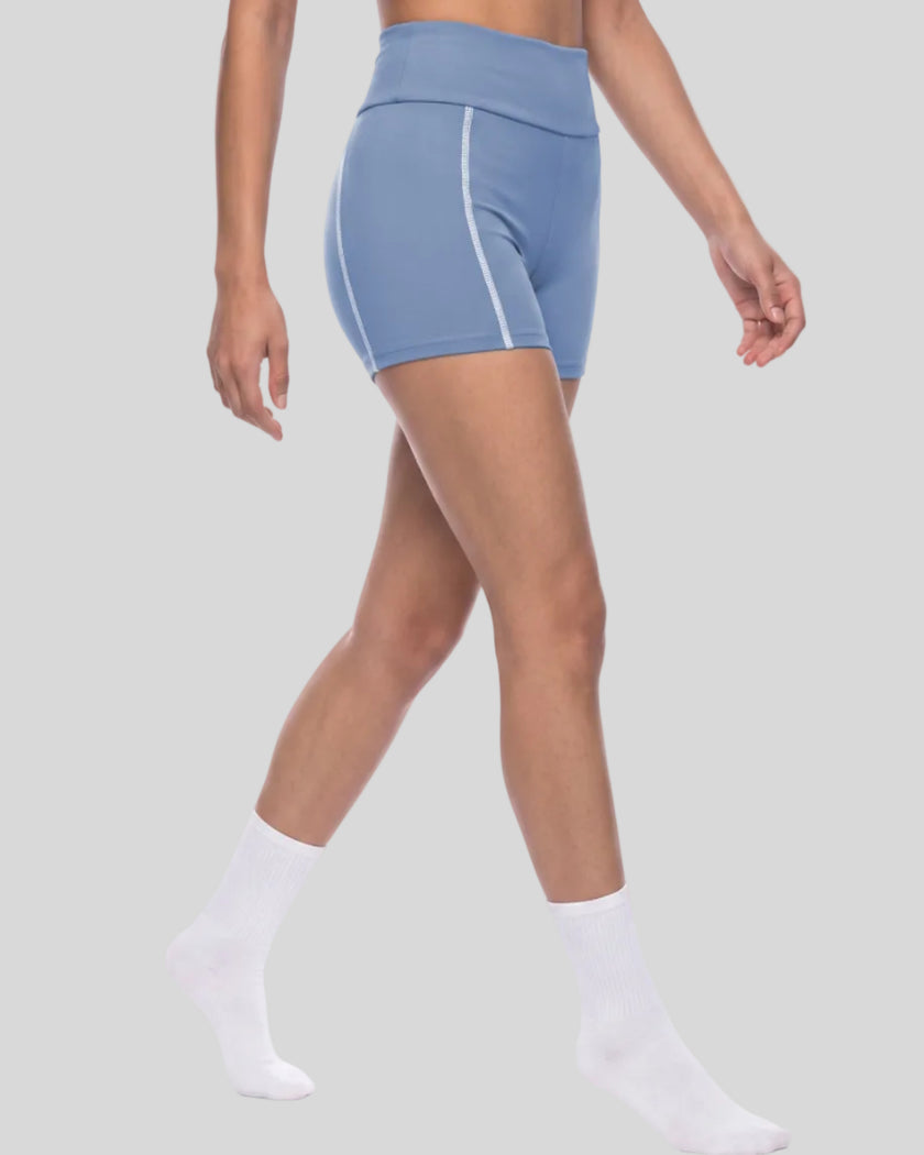 Lower body angled side view of woman wearing TrackLine Yoga Shorts in blue