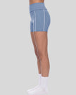 Lower body side view of woman wearing TrackLine Yoga Shorts in blue