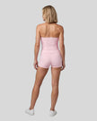 Full body back view of woman wearing pink TrackLine Yoga Shorts with matching TrackLine Halter Yoga Top