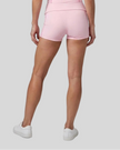 Lower body back view of woman wearing TrackLine Yoga Shorts in pink