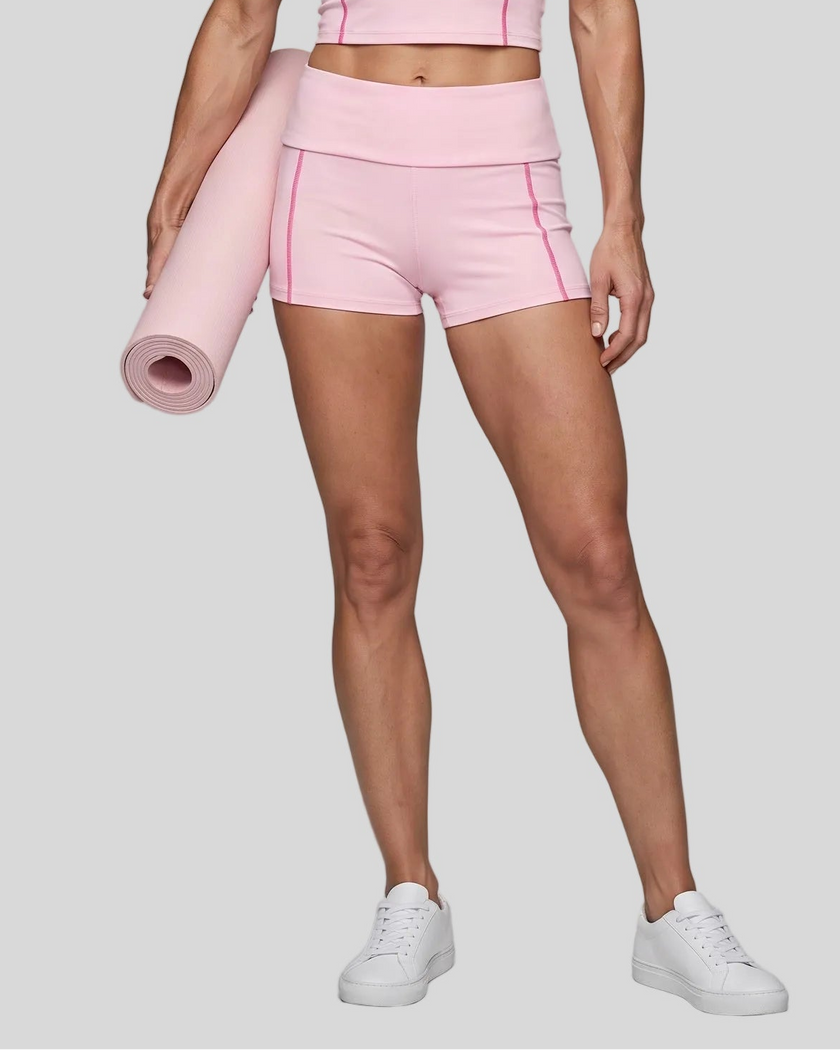 Lower body front view of woman wearing TrackLine Yoga Shorts in pink
