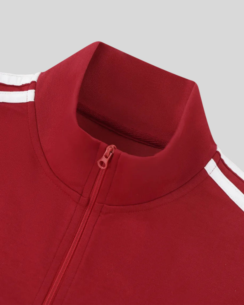 Closeup of the mock neck collar and front zipper detail on the Athlesi TrackLine Zip Crop Tee in red