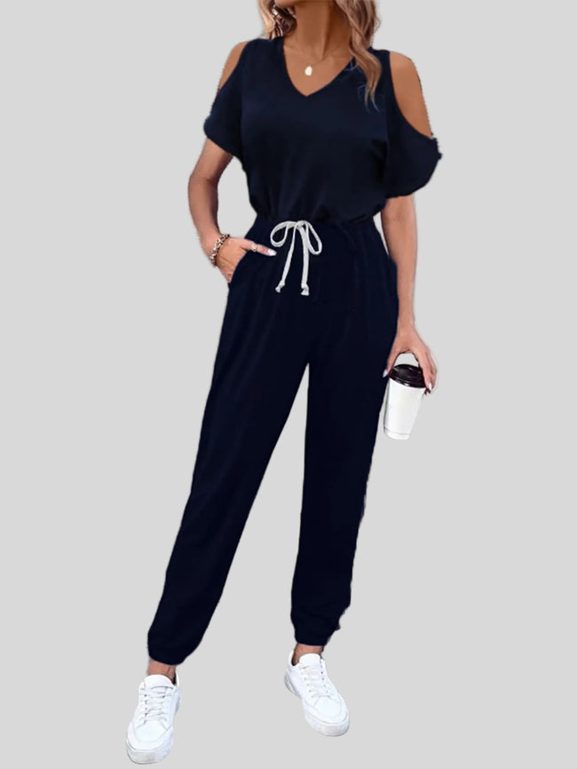 Dark blue cold-shoulder jumpsuit with relaxed fit and pockets, front angle view