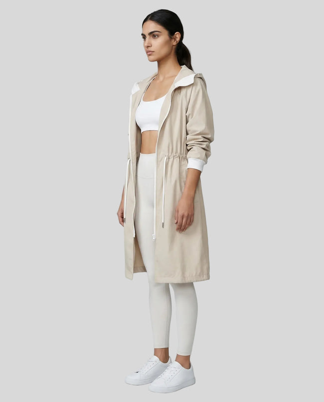 UrbanFlow Hooded Trench in dust storm worn by model full body side view styled in a clean studio setting