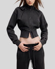 Angled front view of woman wearing cropped Vintage Washed Edition Hoodie with contoured seam details in Black