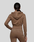 Upper body back view of woman wearing Vintage Washed Edition Hoodie with detachable hood in Coffee