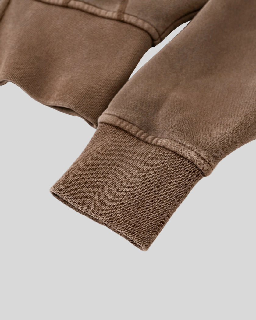 Closeup of vintage washed fabric and ribbed sleeve cuff on Vintage Washed Edition Hoodie
