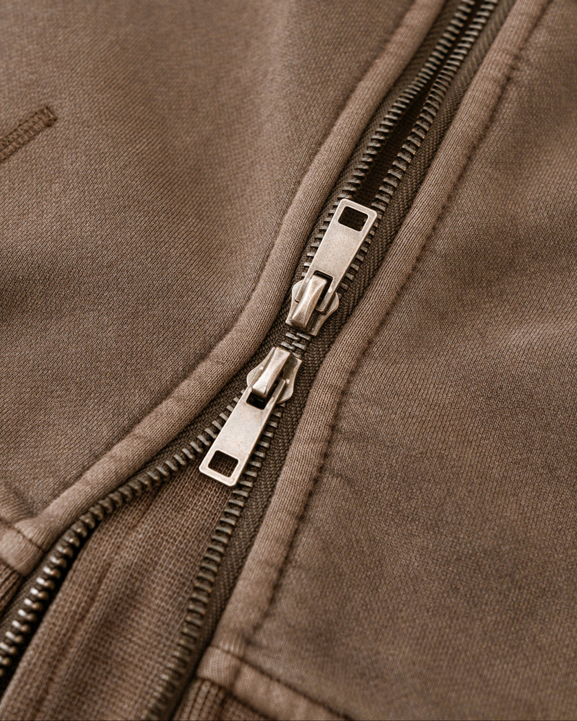 Closeup of metal two-way zipper and vintage washed fabric on Vintage Washed Edition Hoodie