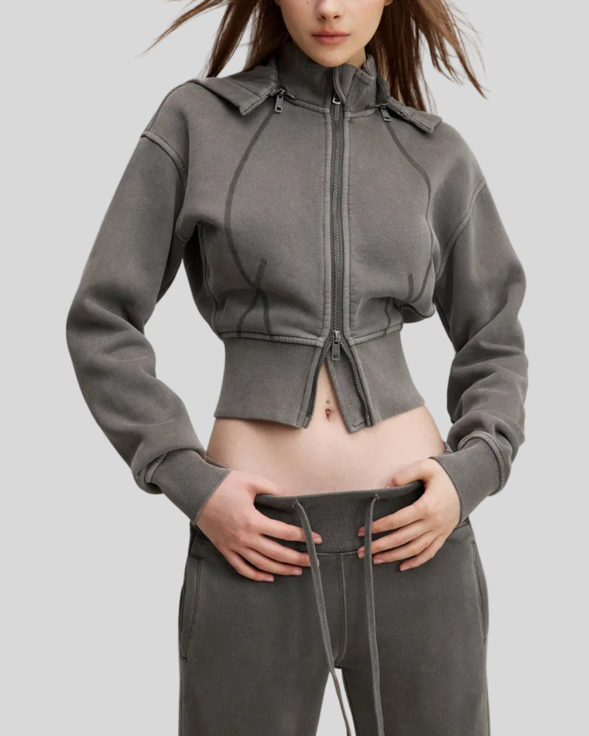 Three-quarter front view of woman wearing Vintage Washed Edition Hoodie with fitted ribbed waistband in Dark Gray