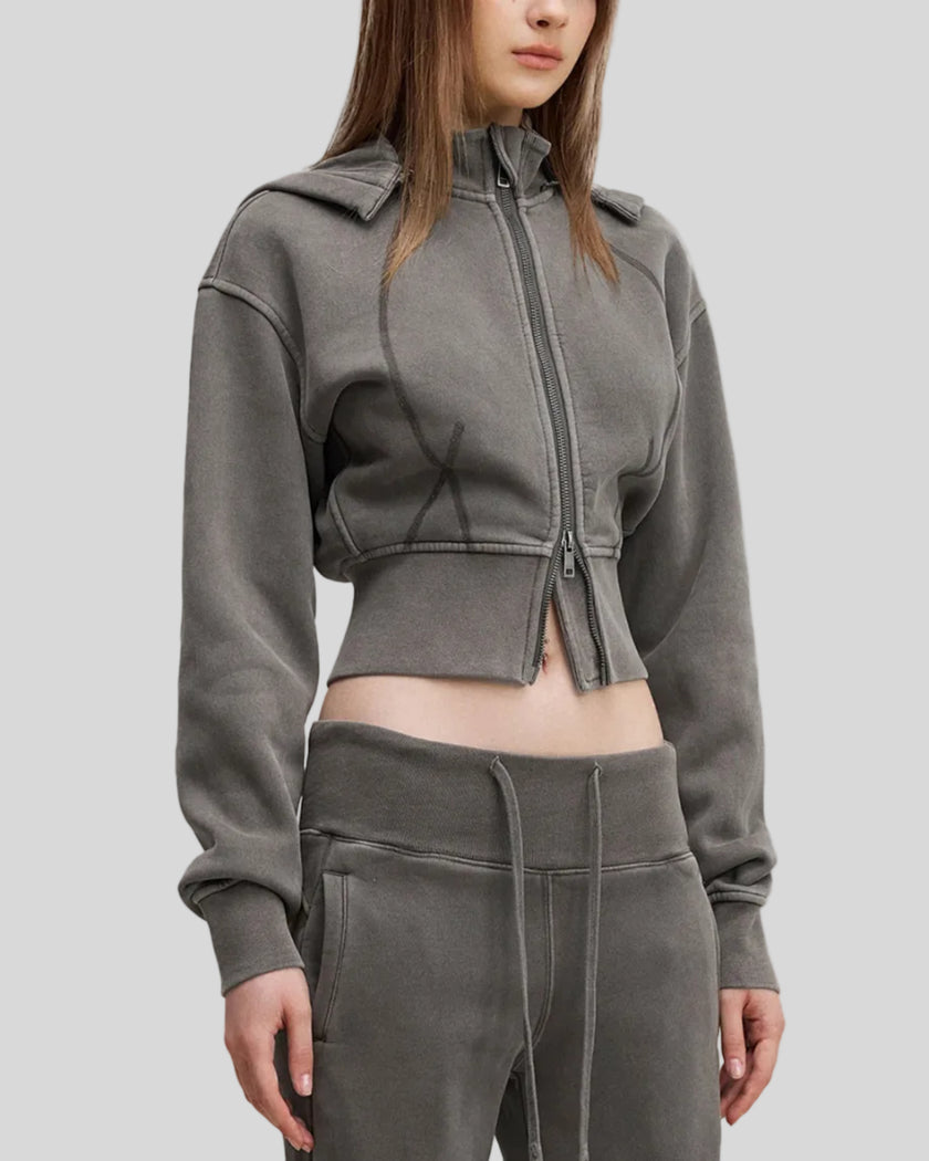 Mid body side view of woman wearing Vintage Washed Edition Hoodie in Dark Gray