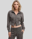 Upper body front view of woman wearing Vintage Washed Edition Hoodie in Dark Gray