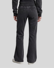 Lower body back view of woman wearing Vintage Washed Edition Pants in Black with flared leg silhouette