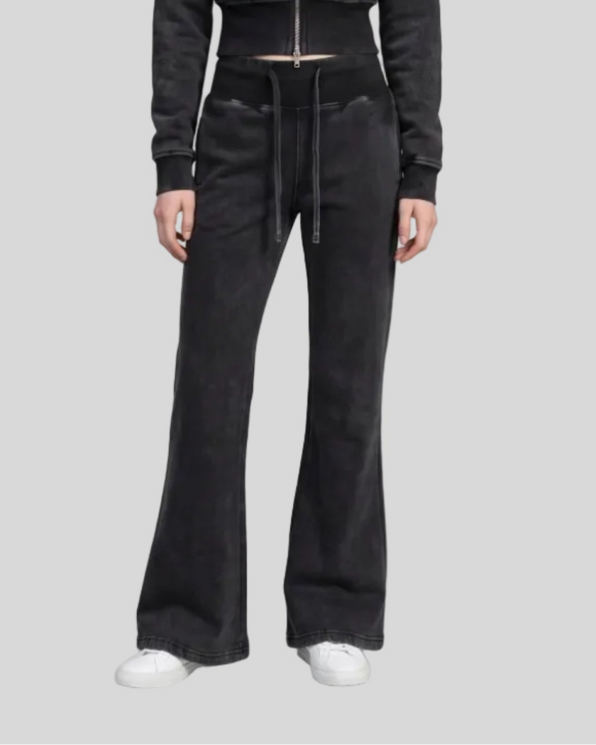 Lower body front view of woman wearing Vintage Washed Edition Pants in Black, showing flared leg silhouette