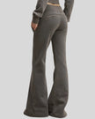 Angled back view of woman wearing Vintage Washed Edition Pants in Dark Gray, showing waistband and leg shape