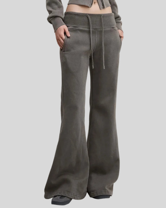 Angled front view of woman wearing Vintage Washed Edition Pants in Dark Gray with fitted hips and flared legs