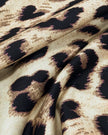 Close-up of leopard print fabric on Athlesi one-shoulder top and pant set