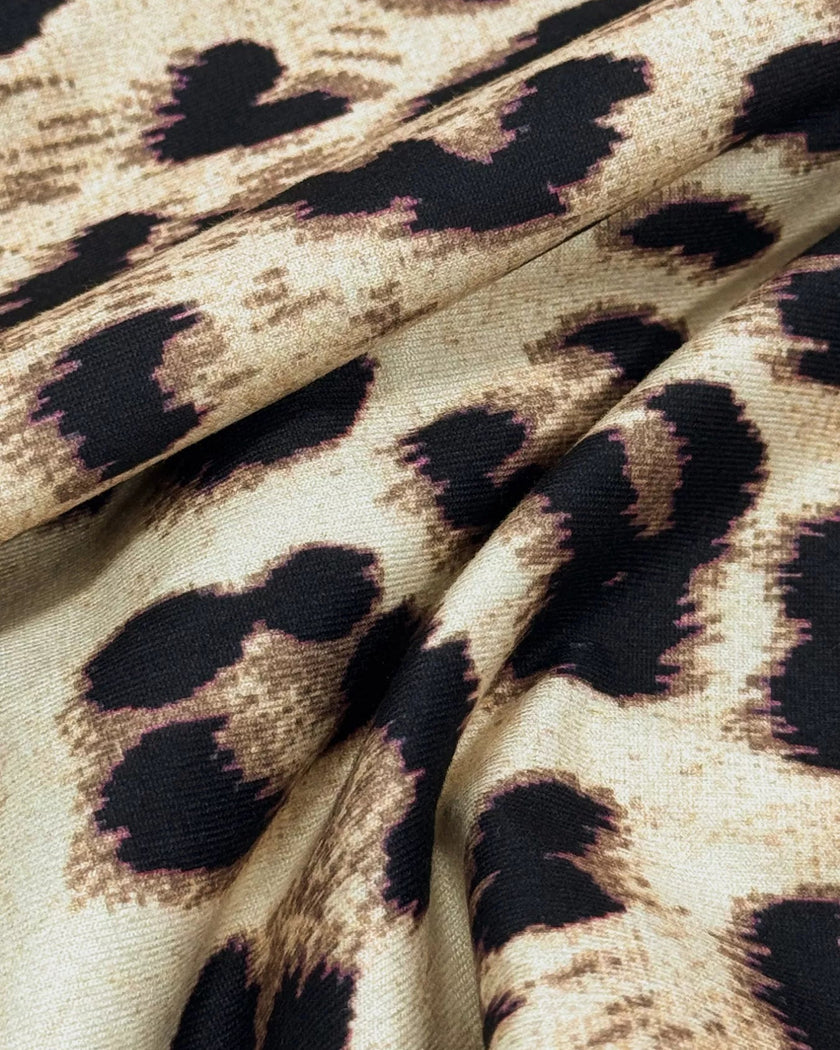 Close-up of leopard print fabric on Athlesi one-shoulder top and pant set