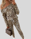 Model wearing Athlesi one-shoulder leopard print top and pant set front view