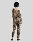 Model wearing Athlesi leopard top and pant set full body back view