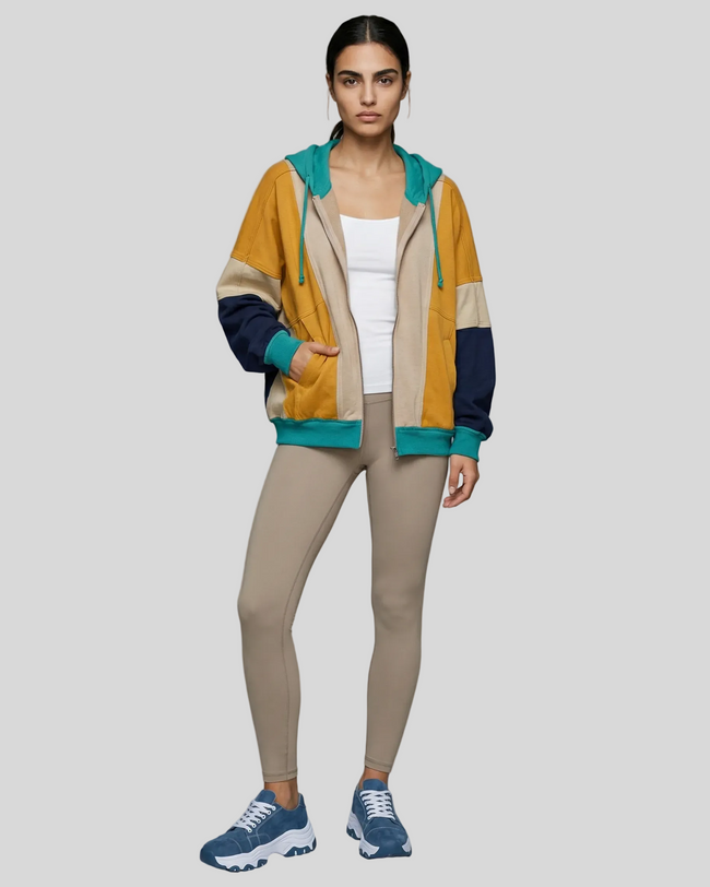 Model wearing the AuraShift Colorblock Hoodie in khaki, styled with Athlesi leggings