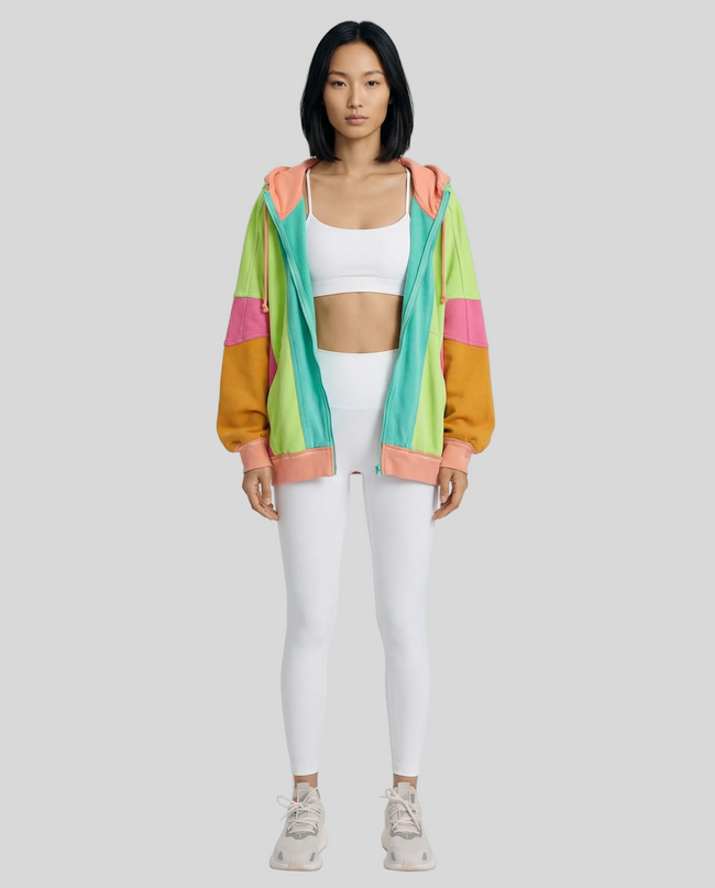 Model wearing the AuraShift Colorblock Hoodie in teal, styled with Athlesi leggings