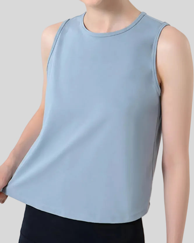 CoreLine Active Tank in light blue, angled front view showing smooth fabric and waist-length cut
