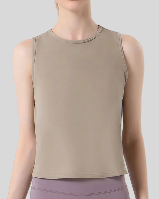 Close-up of CoreLine Active Tank fabric and round neckline detail in tan