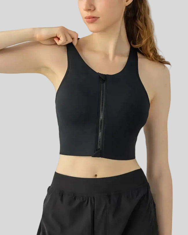 PureEase Essential Sports Bra in black worn by model, featuring a wide straps and medium supportive fit