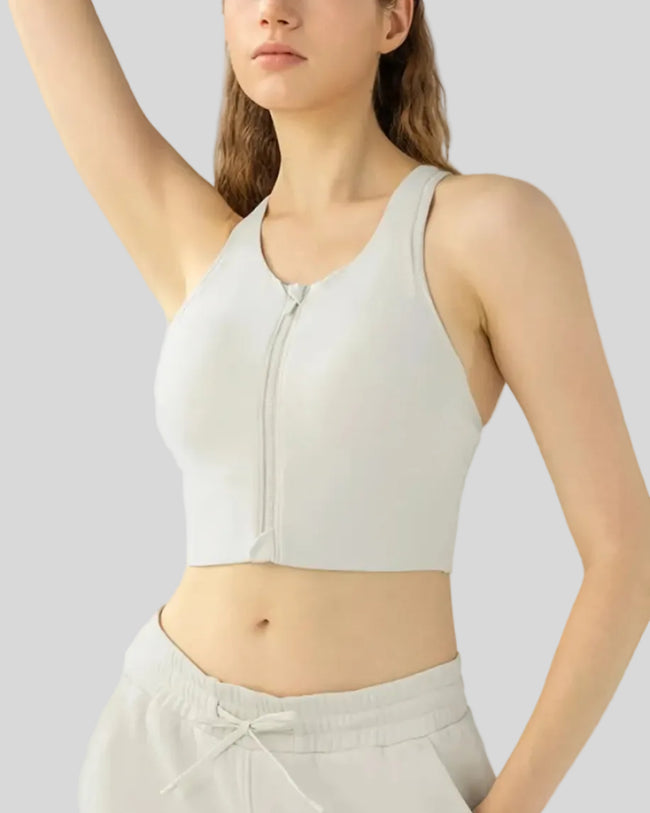 PureEase Essential Sports Bra in ivory worn by model, featuring a wide straps and medium supportive fit