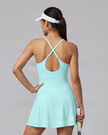 Woman wearing CourtClub Crossback Dress in Sky Blue, mid-body back view highlighting the fitted bodice