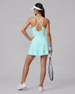 Woman wearing CourtClub Crossback Dress in Sky Blue, mid-body back view highlighting the crisscross straps and open keyhole detail