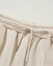 Close-up of pant drawstring detail on UrbanFlow in beige