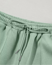 Close-up of pant drawstring detail on UrbanFlow in sage