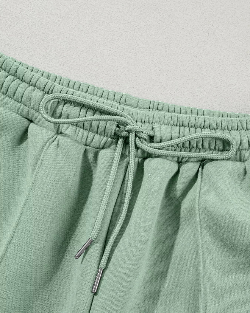 Close-up of pant drawstring detail on UrbanFlow in sage