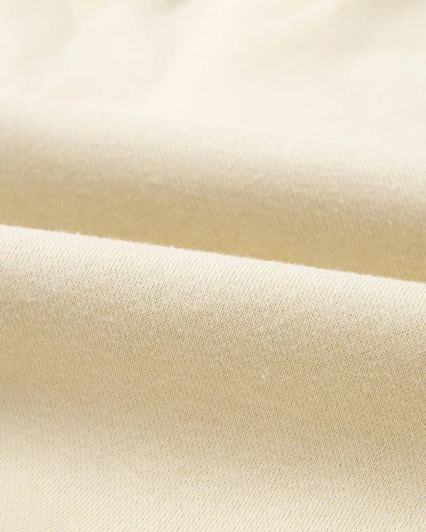 Close-up of midweight knit fabric texture on UrbanFlow set in beige