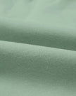 Close-up of midweight knit fabric texture on UrbanFlow set in sage