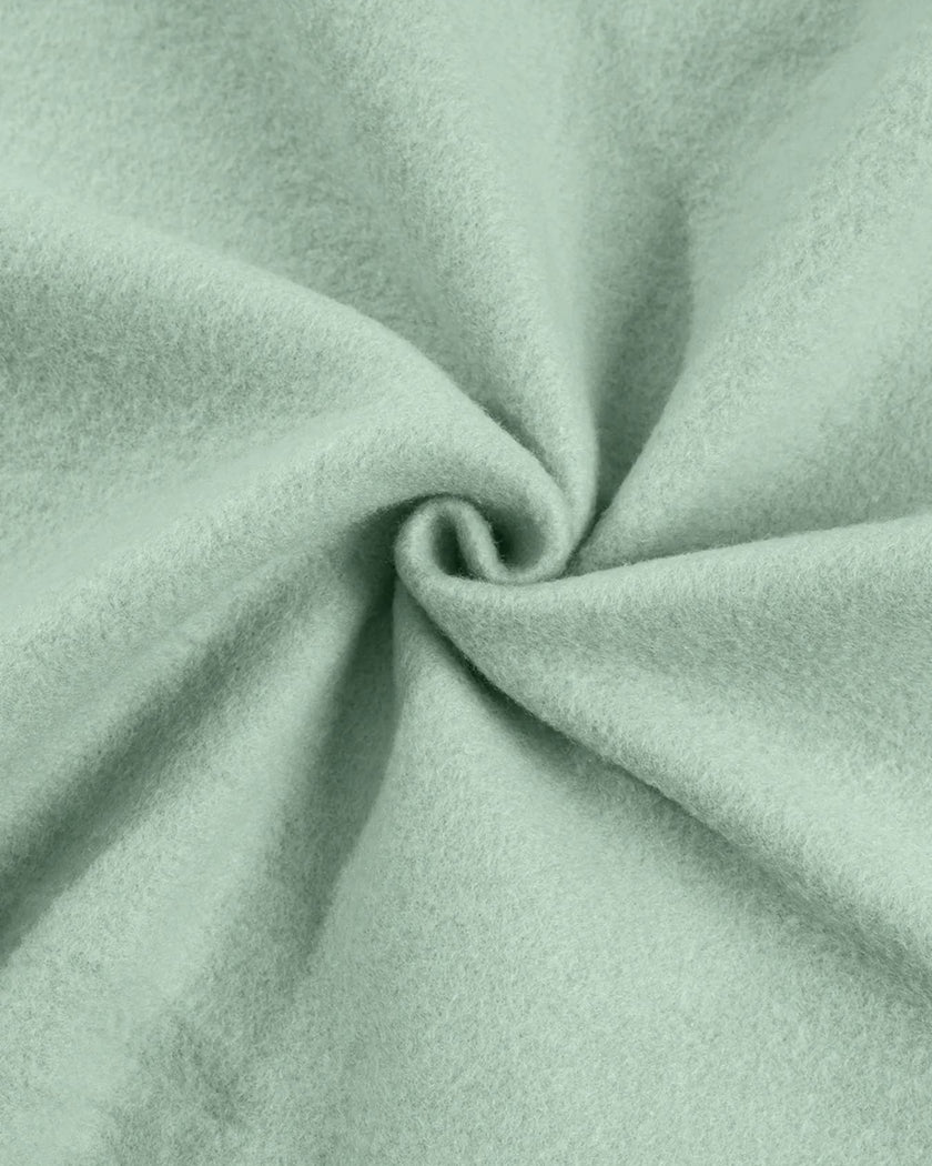 Detailed fabric texture close-up showing soft cotton-blend finish in sage