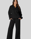 Front angle view of UrbanFlow two-piece jacket and pant set in black