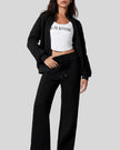 Model wearing UrbanFlow zip jacket and drawstring pants set in black, jacket worn open