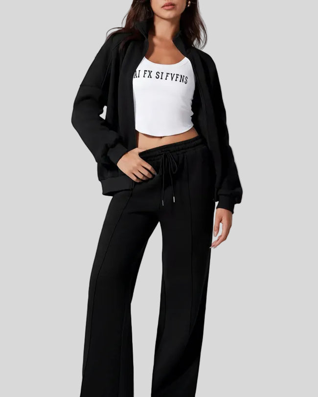 Model wearing UrbanFlow zip jacket and drawstring pants set in black, jacket worn open