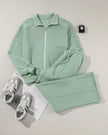 Front flat lay of UrbanFlow zip jacket and pant set in sage