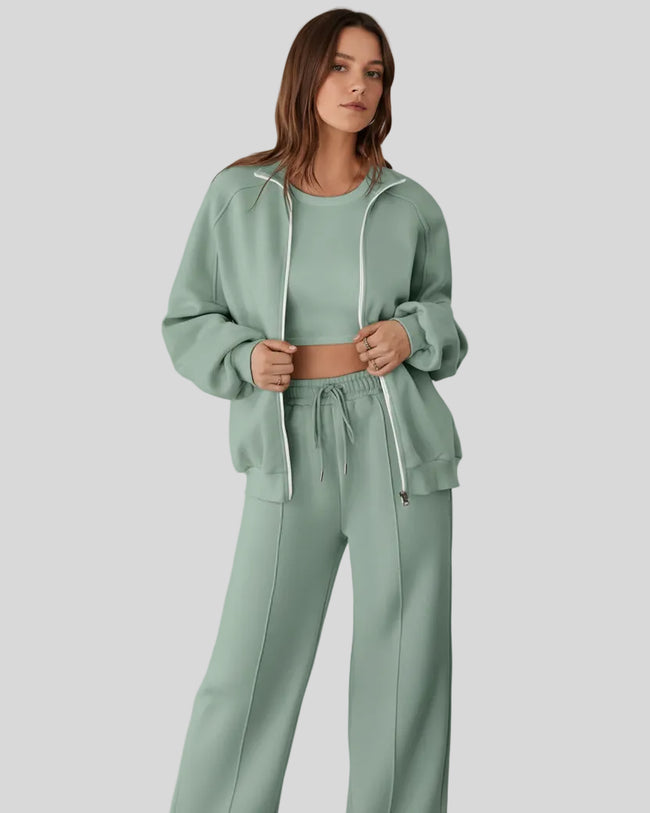 Model wearing UrbanFlow zip jacket and drawstring pants set in sage, jacket worn open