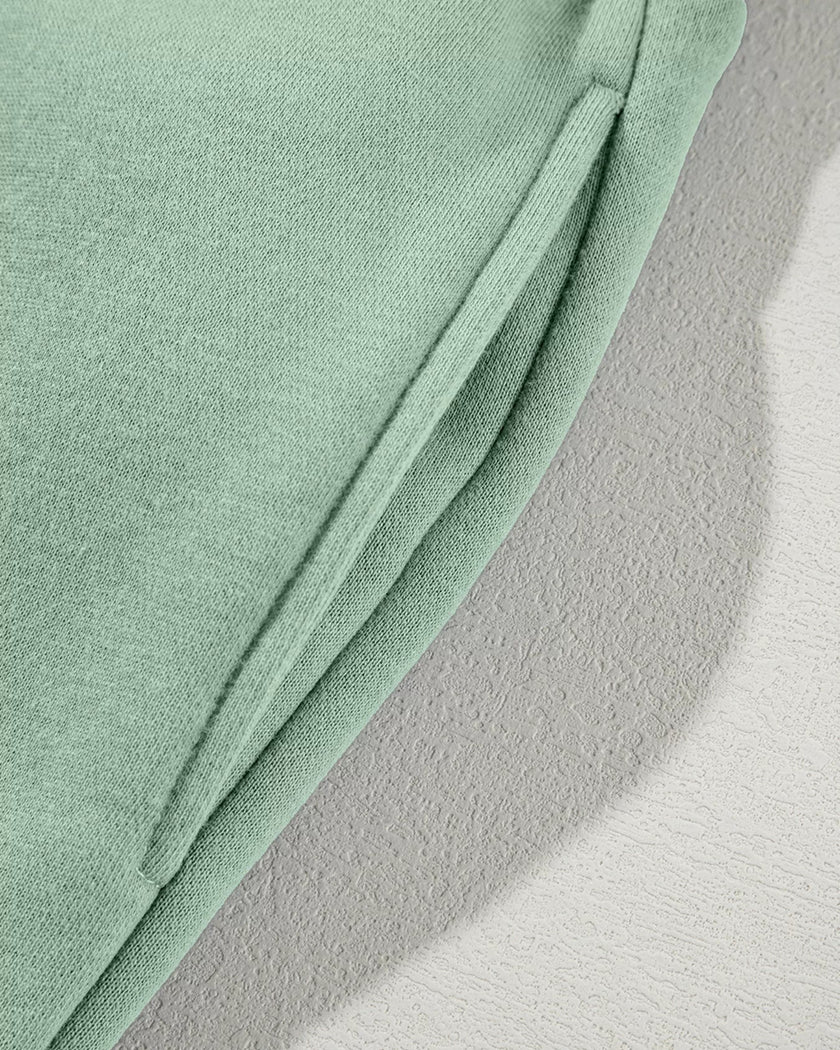 Close-up of functional pocket detail on UrbanFlow jacket in sage