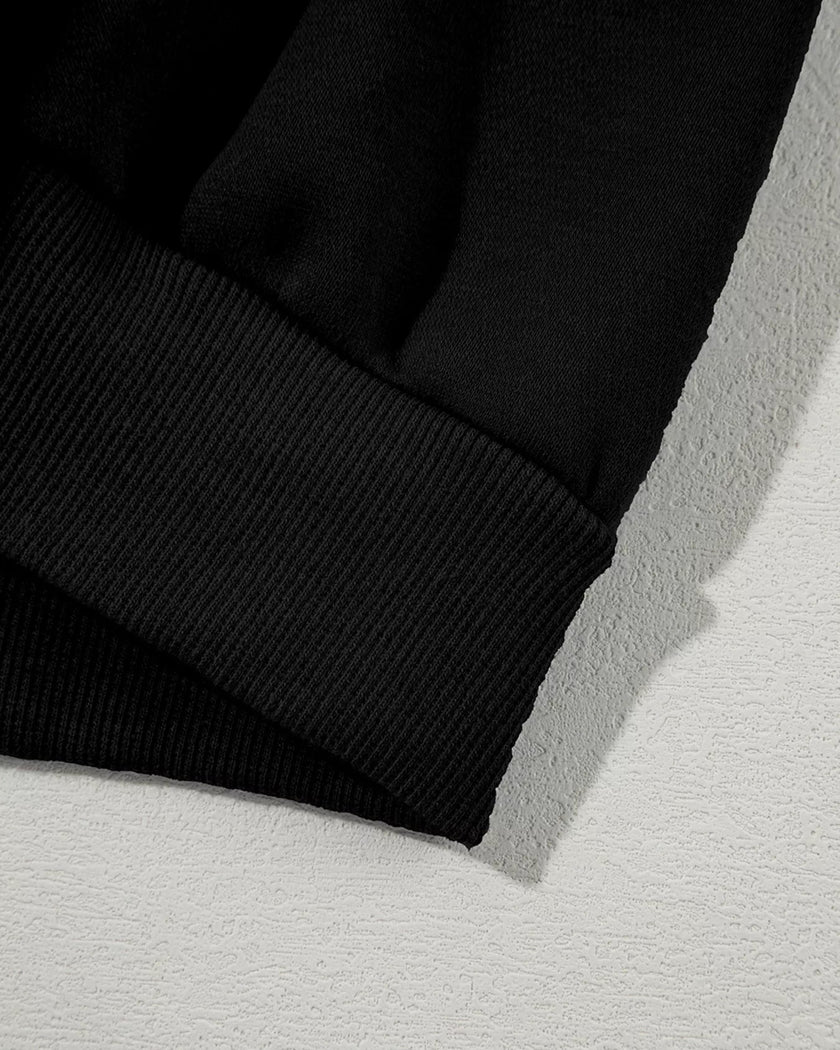 Jacket waistband close-up showing relaxed hem structure in black