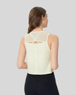 Back view of pastel yellow VeilBack Cropped Active Tank with sheer cutout detail