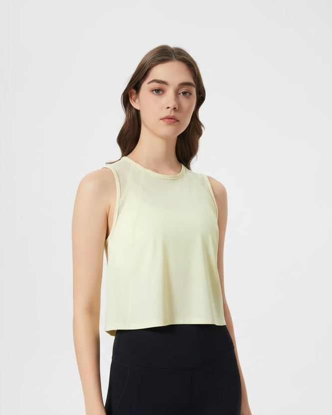 Angled front view of VeilBack Cropped Active Tank in Pastel Yellow